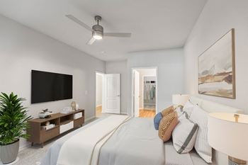 A bedroom with a large bed and a flat screen tv mounted on the wall